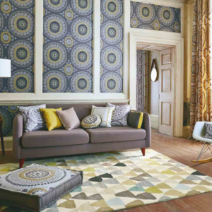 Yellow, green, blue, grey, brown abstract patterned rug by Harlequin