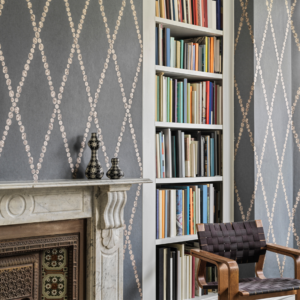 Cole & Son Fornasetti Senza Tempo Cammei Wallpaper - Charcoal coloured wallpaper with small silver circles in a diamond pattern.