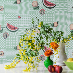 Cole & Son Fornasetti Senza Tempo Frutta Wallpaper - pastel blue coloured wallpaper with abstract shapes and cascading watermelons, peaches and mushrooms.